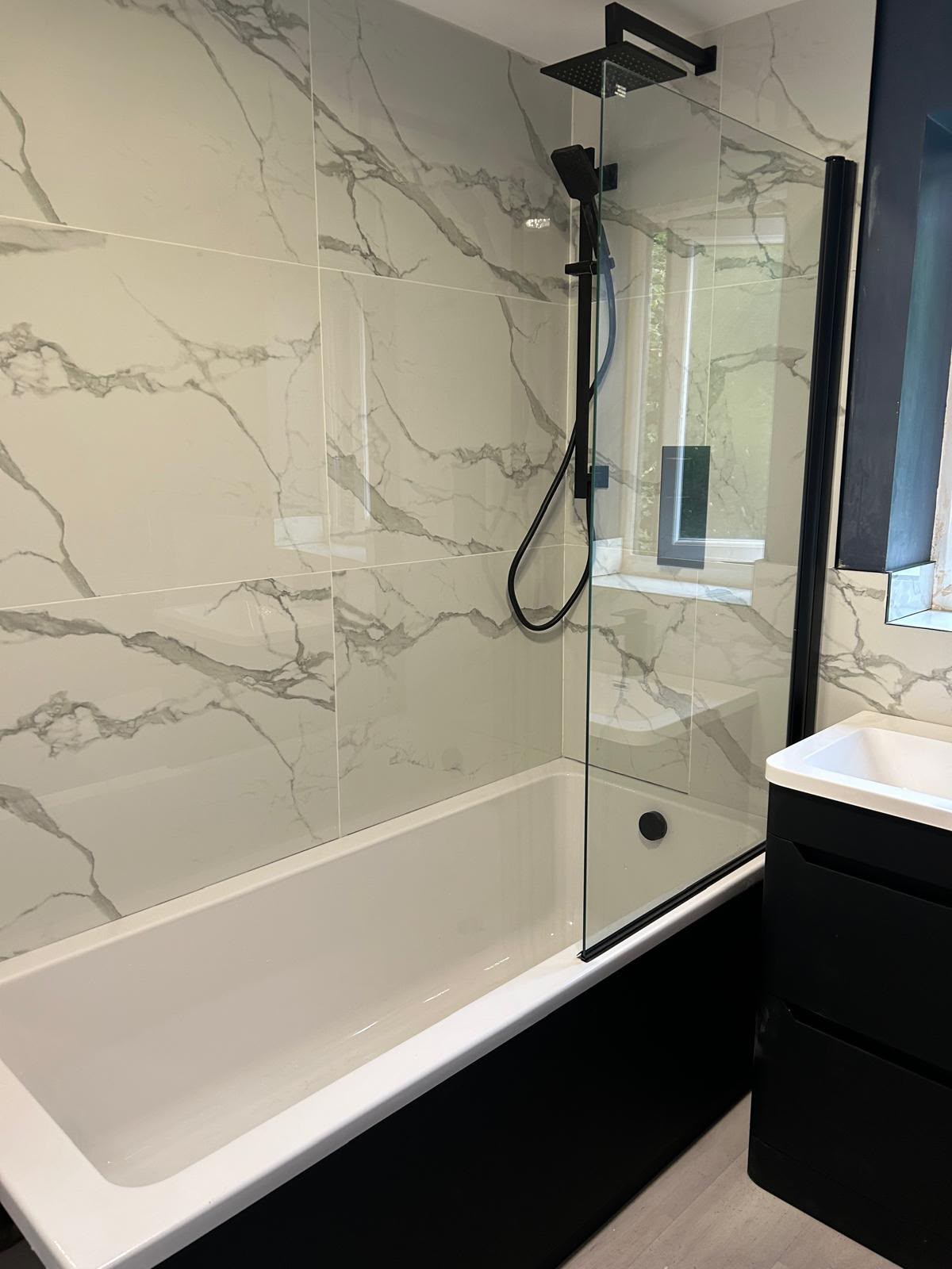 Marble tiled bathroom with shower